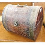 An imitation crocodile skin casket, of oval domed form with lift lid, 28cm high, 35cm wide, 25cm dee