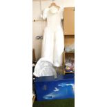 A 1990s wedding dress, together with hoop and veil.