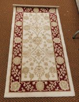A machine made rug by Crossly, 80cm x 150cm.