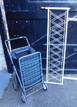 A white metal double headboard and a wheeled carry case. (2)