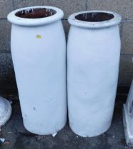 A pair of painted terracotta chimney pots, of cylindrical form, 77cm high.