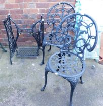 A pair of cast metal garden chairs, together with a Singer sewing machine base.