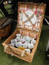 A wicker picnic hamper, containing a quantity of mugs, fitted.