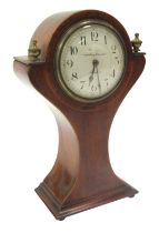 An early 20thC Art Nouveau mahogany and inlaid balloon shaped mantel clock, the circular white ename