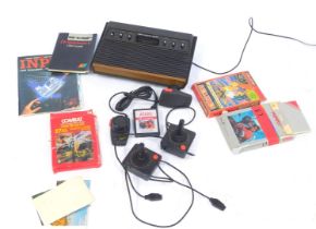 An Atari video computer system, controller, Donkey Kong and Combat, and ET Atari 56 games, and some