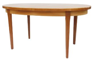 A mid century teak extending dining table, the oval top raised on square tapering legs, 74cm high, t