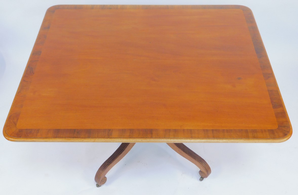 A mahogany and rosewood cross banded dining table, the rectangular top with a rounded edge, on a tur - Image 2 of 5