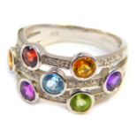 A 9ct white gold multi stone set dress ring, of three layered design, set with semi precious stones,