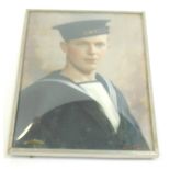 An early 20thC hand tinted photograph depicting a sailor, indistinctly signed, and attributed to Ret