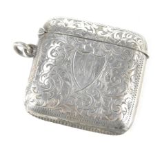 An Edward VII silver Vesta case, of rectangular form with engraved scroll decoration and shield bear