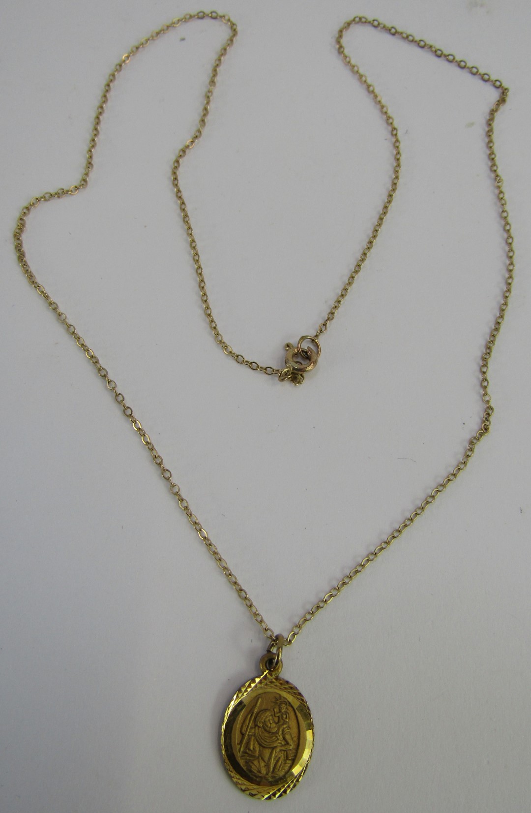 A 9ct gold St Christopher pendant on fine link chain, the pendant 1cm high, the chain 44cm long, 2.2 - Image 2 of 3