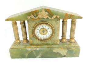 An early 20thC onyx mantel clock, the brass dial with white enamel chapter ring bearing Arabic numer
