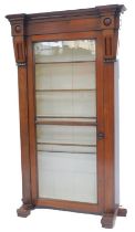 A Victorian mahogany bookcase, the top with a moulded edge, with two carved breakfront panels, the t