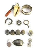 Curios and trinkets, comprising five silver thimbles, silver napkin ring, amber glass cheroot holder