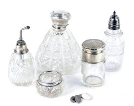 A group of cut glass and silver topped jars, comprising an engine engraved dressing table jar, 9cm h