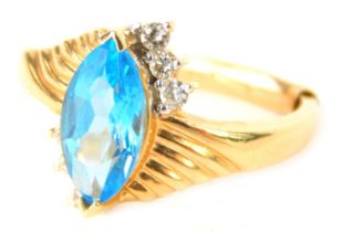 A dress ring, the central shaped marquise turquoise blue stone in crossover setting set with tiny di