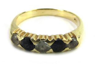 A half hoop dress ring, set with imitation diamond and sapphires, in a claw yellow metal setting, st