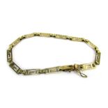 An Eastern inspired bracelet, of Greek key design, yellow metal stamped 585, 18cm long, 4g all in.