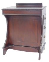 A 20thC mahogany Davenport, with lidded hinged section for pens, the hinged slope enclosing a part s