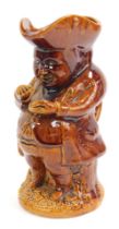 A late 19thC treacle glazed pottery Toby jug, 24cm high.