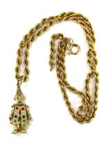 A 9ct gold clown pendant and chain, the clown set with semi precious stones, to include ruby, white