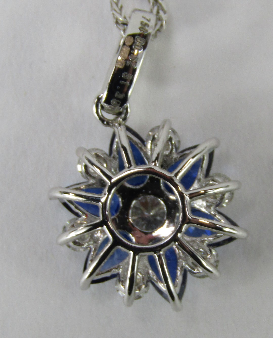 An 18ct white gold, sapphire and diamond pendant and chain, the star design pendant, with three marq - Image 4 of 4