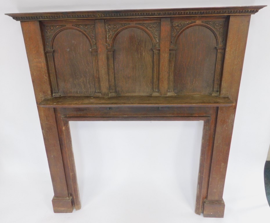 An early 20thC oak fire surround, the carved and moulded top above three arched sections, with carve - Image 2 of 2