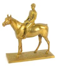 After Otto Rasmussen (German, 1845-1912). A gilt bronzed figure of a jockey and rider, raised on a t