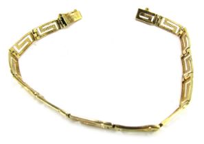 An Eastern inspired bracelet, Greek key design, yellow metal, stamped 585 to clasp, 19cm long, 6.9g