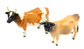 Two Beswick pottery figures modelled as cows, comprising Ickham Bessie 198, paper label and printed