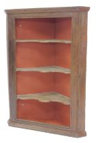 A 19thC oak hanging corner cabinet, the open front enclosing three shaped shelves with a terracotta