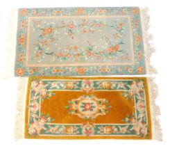 Two Chinese wool cut rugs, in turquoise, 160cm x 92cm, and mustard yellow 69cm x 138cm.