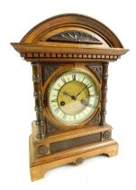 A late 19thC/early 20thC German HAC 14 day strike oak cased mantel clock, the brass circular dial wi