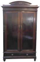 A 19thC mahogany wardrobe, with a raised arched top above a moulded edge with two panelled doors enc