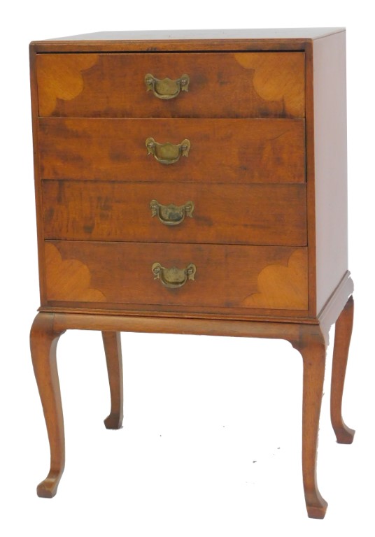 A 20thC mahogany music cabinet, with four drawers with dropped sections, with shaped inlaid panels t