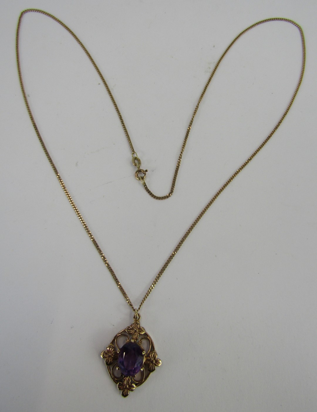 An Elizabeth II 9ct gold pendant and chain, with an oval cut amethyst, in a crown shaped claw settin - Image 2 of 3