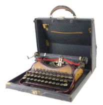 A Smith & Corona cased typewriter, in maroon.