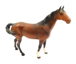 A Beswick matt pottery figure of a horse, in brown, printed marks, 21cm high.