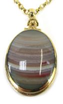 A Victorian semi precious stone set locket and chain, the oval locket set with black agate and strip