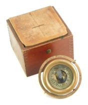 A brass ship's compass, contained in a stained pine case, 12cm wide.