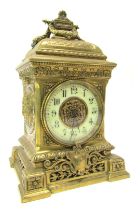 A late 19thC French brass cased mantel clock, the circular cream enamel dial bearing Arabic numerals