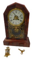 A late 19thC American rosewood cased mantel clock, circular brass dial with chapter ring bearing Rom