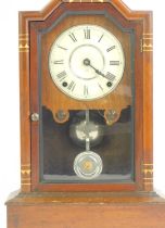 An early 20thC mahogany cased American mantel clock, the white enamel dial bearing Roman numerals, e