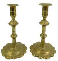 A pair of 18thC brass candlesticks, each with a petal rim and foot, 21cm high.