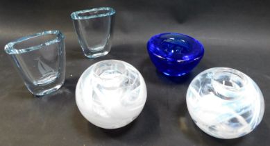 A pair of Kosta Boda glass tea light holders, of globular form with recess for tea light, decorated