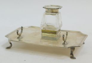 A George V silver and cut glass desk stand, of canted rectangular form, with a cut glass inkwell, wi