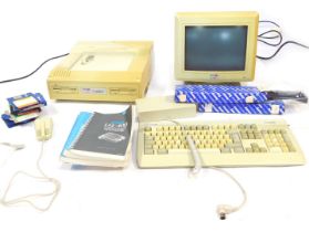 An Amstrad White PC 12MD, and a 8086 processor, with ram manuals and keyboard. (a quantity)