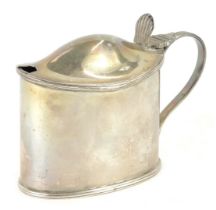 A Victorian silver mustard pot, of oval form, with a shell engraved thumb press, the body initial en