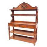 A 19thC Continental mahogany buffet, the top with a raised scroll carved back above two shelves, the