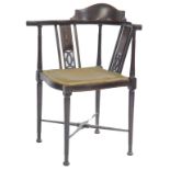 An Edwardian mahogany and inlaid corner chair, with pierced two section back, overstuffed seat, on t